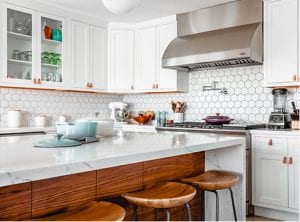 white and brown kitchen island with octagon backsplash and white cabinets